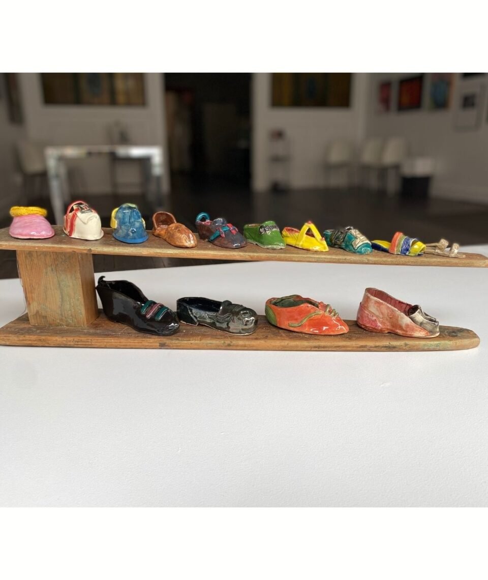 14 Shoes Suitable for Domestic Labour ceramic shoes placed on an old wooden sleeve ironing board 